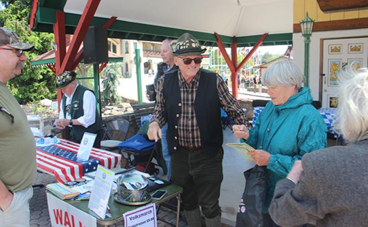 Rod Powell helps folks with registration at last year’s Volksmarch walk. (file photo)