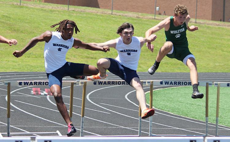 WCHS'  Vondre Nelson, left, and JT Gerrell, along with Wesleyan's Porter Hallock clear the first hurdle in the 110-meter race. Gerrell won the race, while Nelson won the 300-meter hurdles later in the meet.   (Photo/Mark Turner)