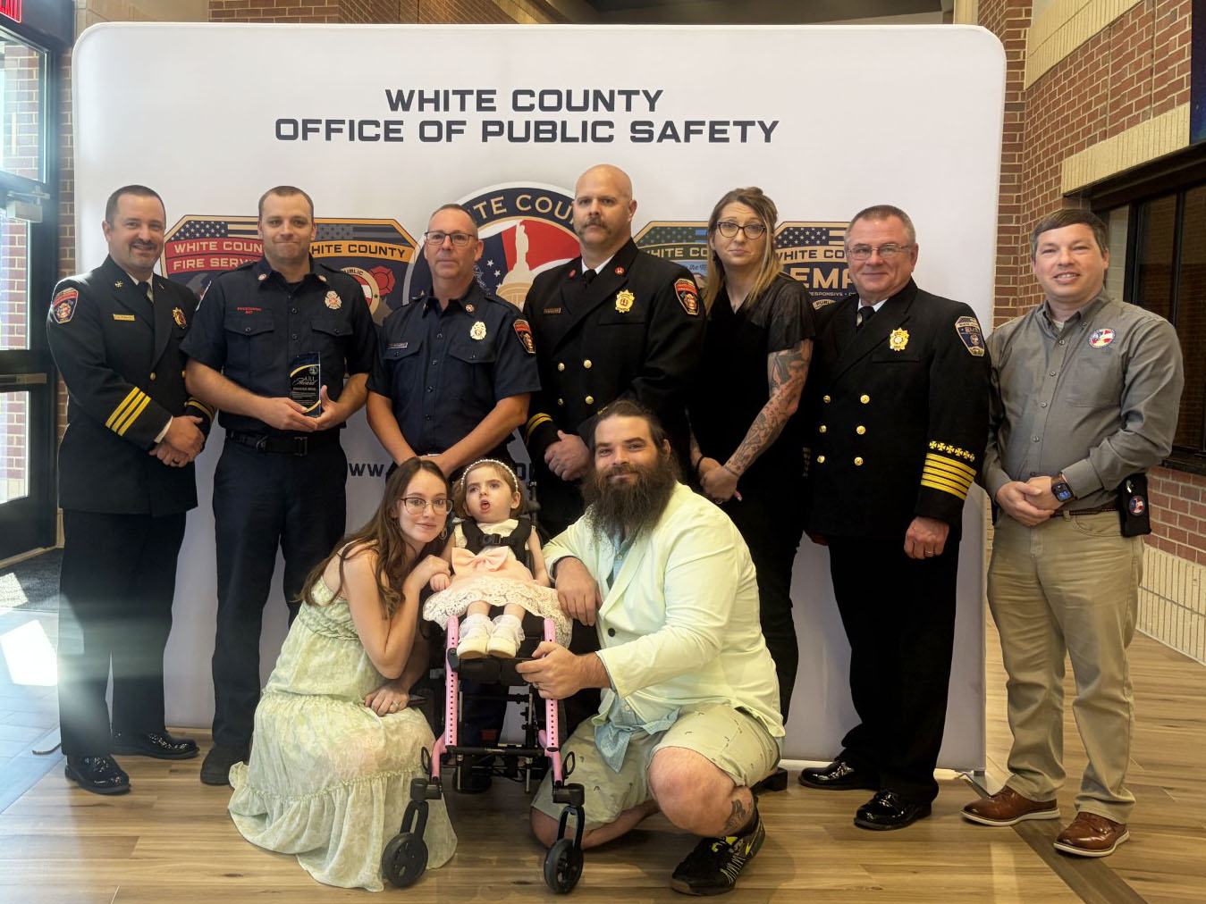 Pictured with Hanna and Patrick Day and daughter Aurelia are, from left, public safety personnel Josh Taylor, Trace Swoszowski, Terry Stewart, Jody Holland, Jessica Wood, Don Strength and Jonathan Jones with GEMA. See more photos on page 6A. SUBMITTED PHOTO