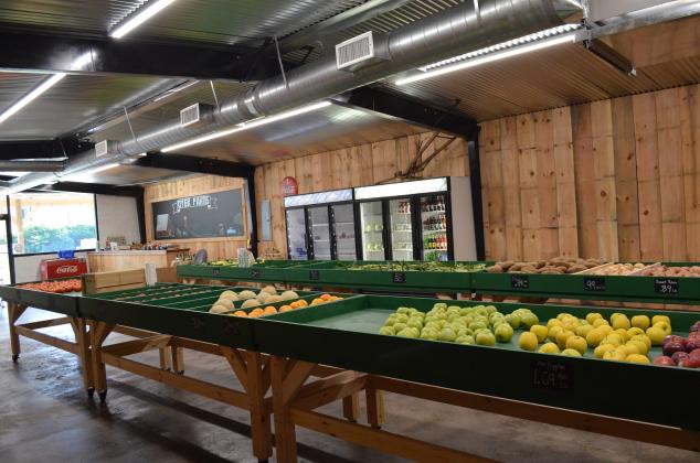 After a busy first weekend, Mike Dyer is busy restocking the variety of fresh produce offered at Dyer Farms Store.  (Photo/Stephanie Hill)