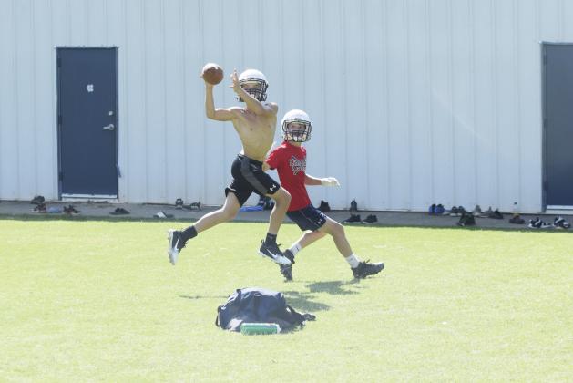 Cam Wilson, left, jumps in front of receiver Trevor Butler to pick off a pass during a one-on-one drill Tuesday morning at the White County Middle School stadium. (Photo/Mark Turner)
