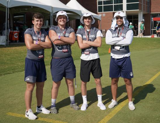 Cooper Turner, left, Cameron Sizemore, Eli Palmer and Corry Ezzard strike a pose while watching the Falcons' practice session.