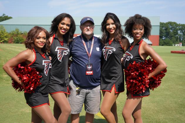 WCHS assistant coach Darrell Dorsey poses for a photo with members of the Atlanta Falcons' dance team during the Falcons' event.