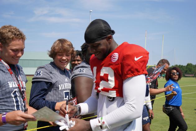 Atlanta Falcons' receiver Mohamed Sanu, right, signs an autograph for Caden VerSluis and Alex Thornton after practice.