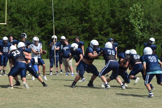 Offensive lineman Jacob Anderson, left, works against Eli Godfrey during an 11-on-11 drill at practice last week. (Photos/Mark Turner)