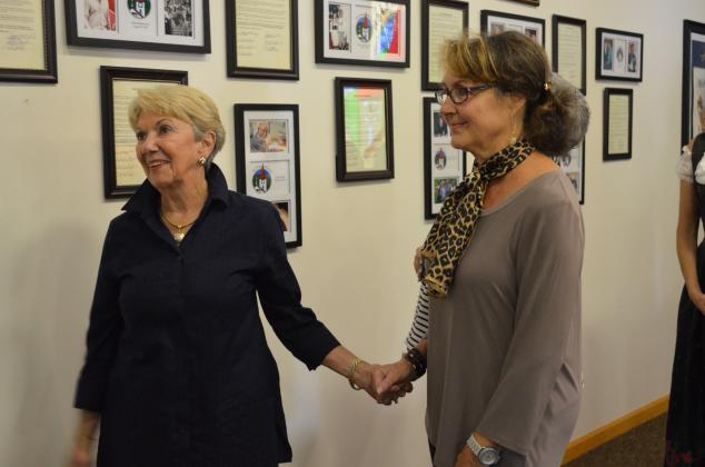 : Linda Fowler grabbed Helen Wilkins hand after the display for Bob Fowler was installed onto the Helen Heritage Hall of Fame. (Photo/Stephanie Hill)