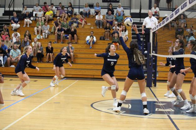 Kyleigh Johnson, right, sets up Hope Thomas for a kill during thea win over West Hall. (Photo/Staci Sulhoff)