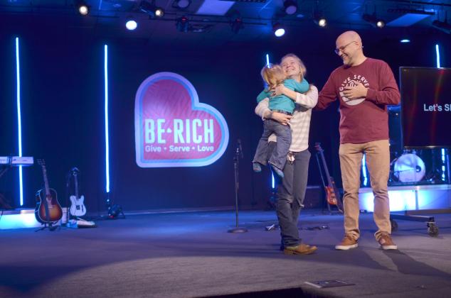 A tearful Tori Griffin got a hug from her daughter after The Bridge Church Lead Pastor Patrick Ballington shared that she’d be receiving a 2007 SUV after being in need of transportation. The announcement was one example of generosity at the church’s Nov. 24 service highlighting the Be Rich giving campaign. (Photo/Wayne Hardy)