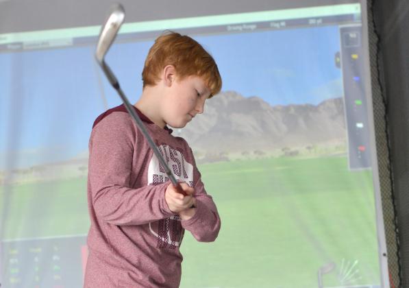 Camden Mincey of Sautee tries the golf simulator.
