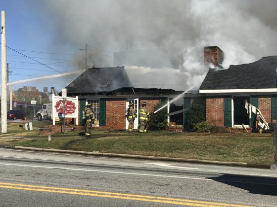 Firefighters work to extinguish the flames at J.W. Reeds Tavern. (Photo/Stephanie Hill)