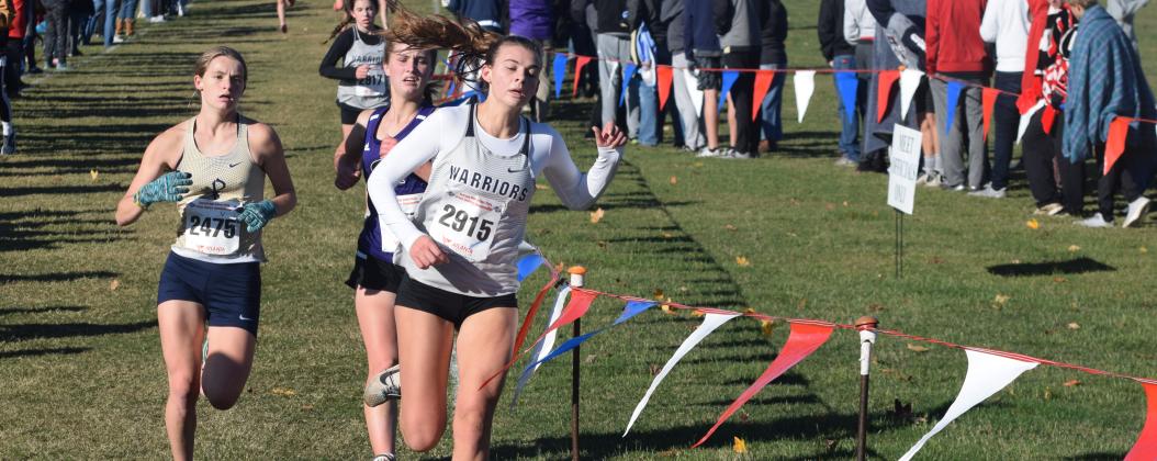 White County's Ellie Gearing, right, holds off St. Pius' Cala McEachron, left, and Chapel Hill's Francie Butts during the final 50 yards of the Class AAAA race to become the first Lady Warrior to cross the finish line. (Photo/Mark Turner)