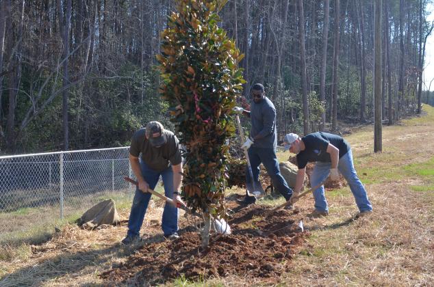 Freudenberg-NOK’s Chuck Klekot, Desmond Salmon and Cleveland Plant Manager Wyman Hare team up to plant a tree at the Yonah Preserve Ballfield Complex. (Photo/Wayne Hardy)