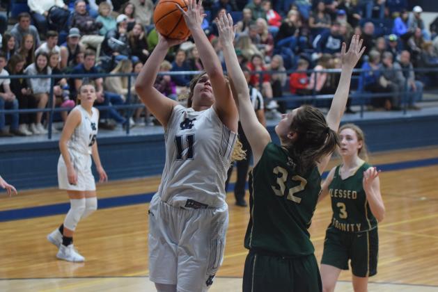 Maddie Futch scores over Blessed Trinity's Erin Hynekamp during the Lady Warriors' region win Tuesday night in Cleveland. (Photo/Mark Turner)