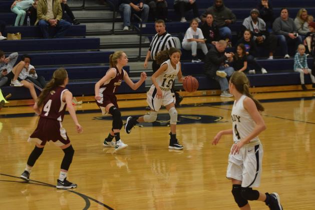 Aaliyah Anderson, right, dribbles past a Dawson County defender during the eighth-grade matchup Monday afternoon in Cleveland. (Photo/Mark Turner)
