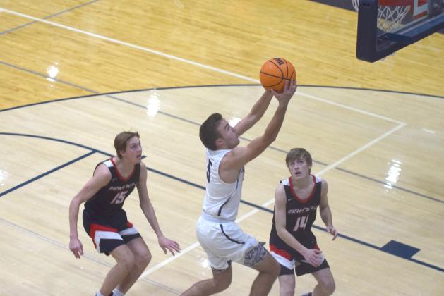 Reece Dockery finishes off a move to the basket during the Warriors' win over Flowery Branch Tuesday night in Cleveland. (Photos/Mark Turner)