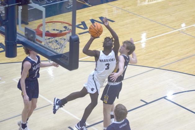 Silas Mulligan gets off a shot in traffic during the opening quarter of the region game against Marist Tuesday night in Cleveland. (Photos/Mark Turner)