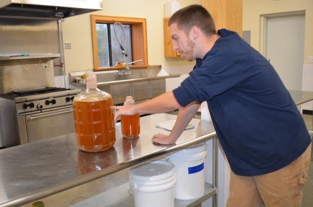 Lane Williams shows an example of the mead. (Photo/Stephanie Hill)