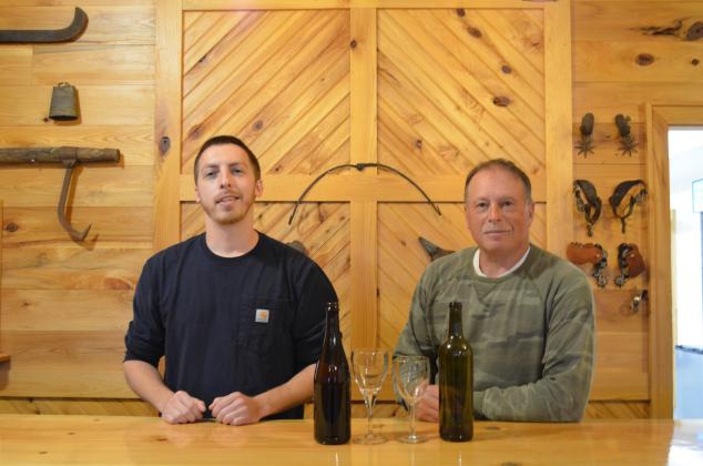Lane Williams and Lloyd Allison stand behind the bar in the tasting room for Tesnatee River Winery and Meadery. (Photo/Stephanie Hill)