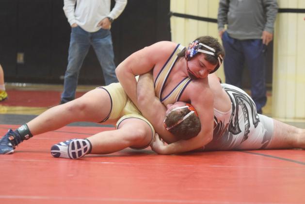 White County's Devin Sullens pins Flowery Branch's Clayton Walczuk to win the Region 7-AAAA championship match in the 285-pound division. Sullens had a pair of pins during the region tournament last Saturday at Flowery Branch High School, and earned a spot in the Class AAAA sectionals this weekend in Perry. (Photo/Mark Turner)
