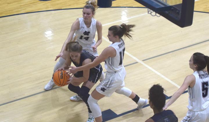 Naomi Crumley, left, and Ellie Gearing put some defensive pressure on West Hall's Amber Hughes during the tournament opener Tuesday night in Cleveland. (Photos/Mark Turner)