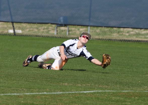 Jake Johnson dives to make a play on a ball during the Warriors' home opener against Habersham Central Saturday in Cleveland. (Photo/Staci Sulhoff)