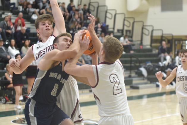 White County's Reece Dockery tries to get off a shot between Chestatee's Ethan Popham, left, and Dylan Travis during the tournament game Monday afternoon in Roswell. (Photo/Mark Turner)
