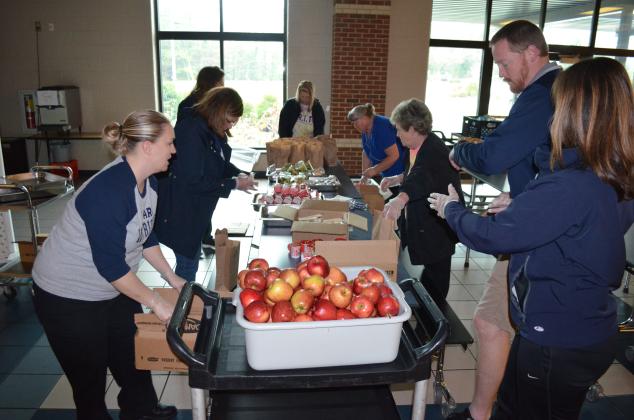 White County School System administrators, White County Middle School administrators and nutrition staff worked hard on Monday, March 16, to pack breakfast and lunches for students. (Photo/Stephanie Hill)
