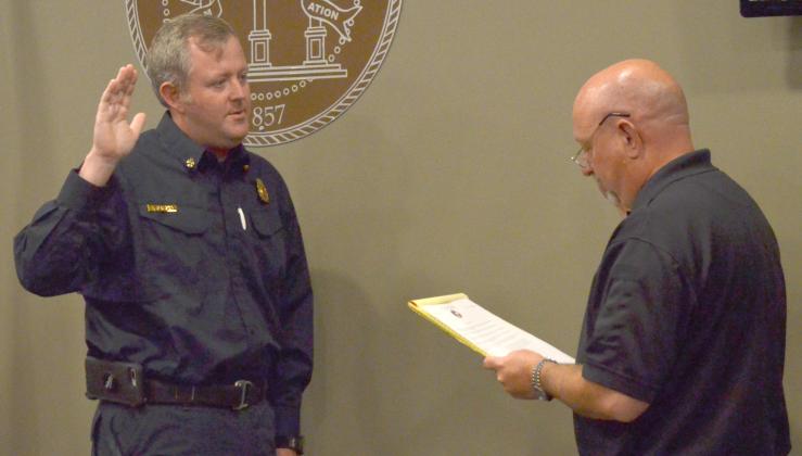 New White County Fire Chief Seth Weaver recites an oath administered by county Public Safety Director David Murphy on Monday. (Photo/Wayne Hardy)