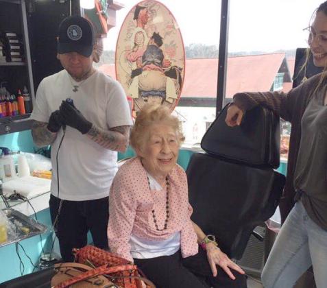 Tattoo artist Mark Ayers prepares to place a design  on 100-year-old Araminta “Mitzi” Bythewood of Cleveland. (Photo courtesy Ashlyn Turner)