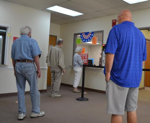 Voters arranged in a socially distanced line wait to cast their ballot Tuesday at the White County Voter Registrar’s Office. (Photo/Stephanie Hill)