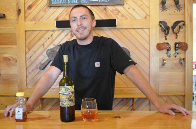 Lane Williams shows off the 2019 Tesnatee River rosé wine that took home the silver award in the 2020 Experience Rosé Competition. (Photo/Stephanie Hill)