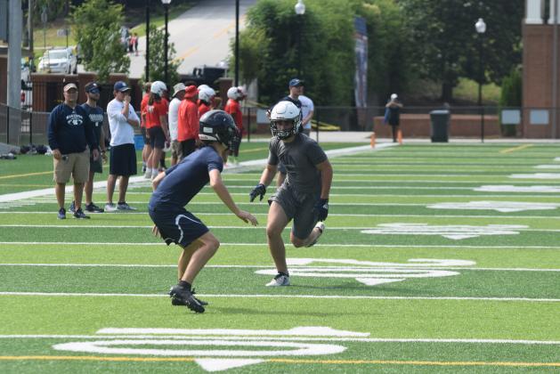 The Warriors, including senior receiver Cooper Turner, right, won't be able to compete in 7-on-7 events in June due to the COVID-19 pandemic. The team will open summer workouts next week at the high school complex.