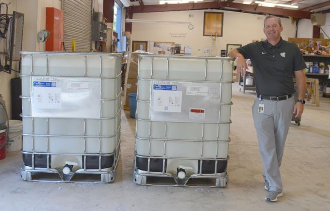 White County School System Assistant Superintendent Scott Justus shows off the 640 gallons of hand sanitizer the school system purchased for this year. (Photo/Stephanie Hill)