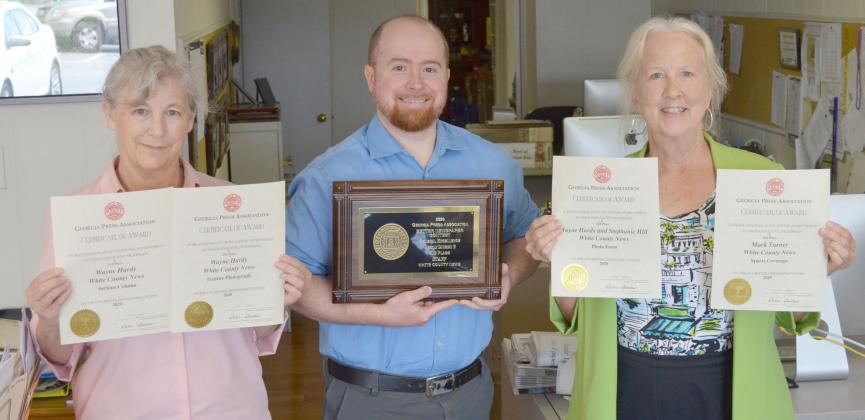 From left, White County News office manager Susan Egan, Editor &amp; Publisher Wayne Hardy and marketing specialist Aileen Hood hold some of the newspaper’s recent awards from the Georgia Press Association Better Newspaper Contest.