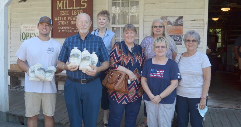 From left, Nora Mill Granary operator Joe Vandegriff presents a donation to Michael Parker, Beth Fine, Ann Helms, Sharon Worrell, Cathy Risener and Wendy Groman. (Photo/Wayne Hardy)