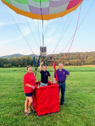 J.T. Head III, center, is now the world’s youngest pilot at only 8 years old flying a specially designed hot air balloon flying over Sautee Nacoochee. He’s shown with parents Desiree and Tarp Head. (Photos courtesy/Tarp Head)