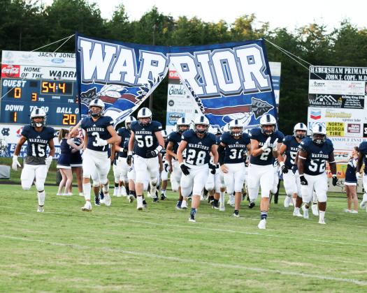 The Warriors, led by, from left, Kane Lowery, Bryson Cronic, Alex Garcia, Seth Stonecypher, Malachi Zellars, Clayton Rogers, and Jaquez Williams charge onto the field for the start of the 2020 season Friday night in Cleveland. (Photo/Staci Sulhoff)