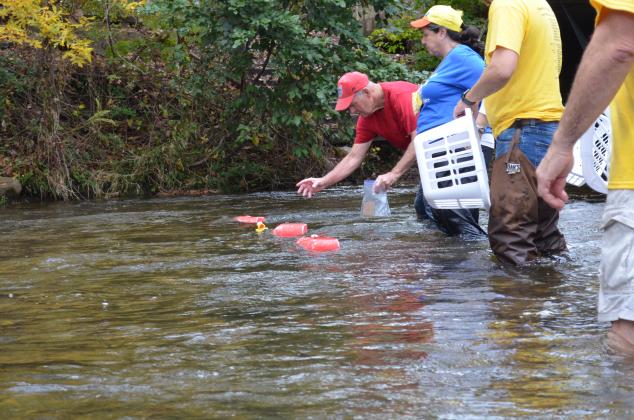 Mike Dixon reaches for one of the 2,400 rubber ducks released into the Chattahoochee River during the event. (Photo/Stephanie Hill)