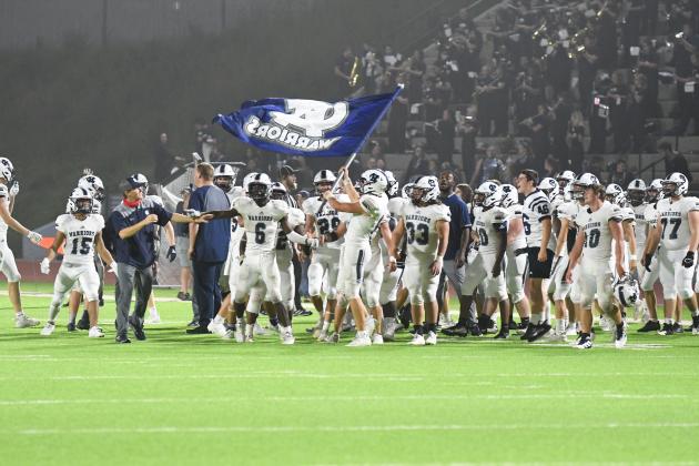 The WCHS players fly the Warrior flag moments after finishing off a 28-21 win over Habersham Central. (Photos/Tom Askew)