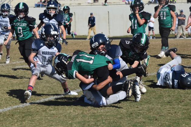 Ryder Rewis of the 8U team makes a tackle during the winning effort. (Photo/Mark Turner)