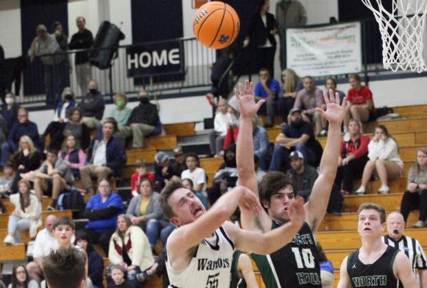 White County's Cooper Turner scores on a layup through North Hall's Robert Terry, No. 23, and Jeremiah Telander during the Warriors' region win over the Trojans Tuesday night in Cleveland. (Photo/Staci Sulhoff)