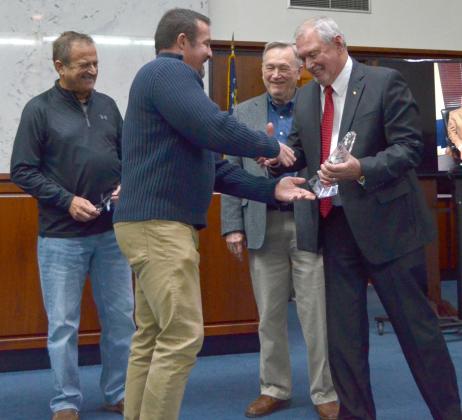 White County Board of Commissioners Chairman Travis Turner (center) presents an award to retiring Probate Judge Garrison Baker (right), honoring his 38 years of service in office during a celebration event Dec. 11. In back, from left, are county commissioners Lyn Holcomb and Terry Goodger. (Photo/Wayne Hardy)