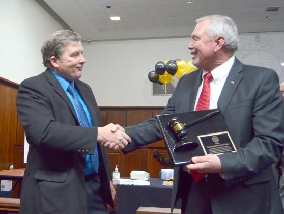 Probate judge-elect Don Ferguson shakes hands with Baker after presenting the retiring probate judge with an honor recognizing his longtime service in the office, on behalf of Georgia’s probate judges.