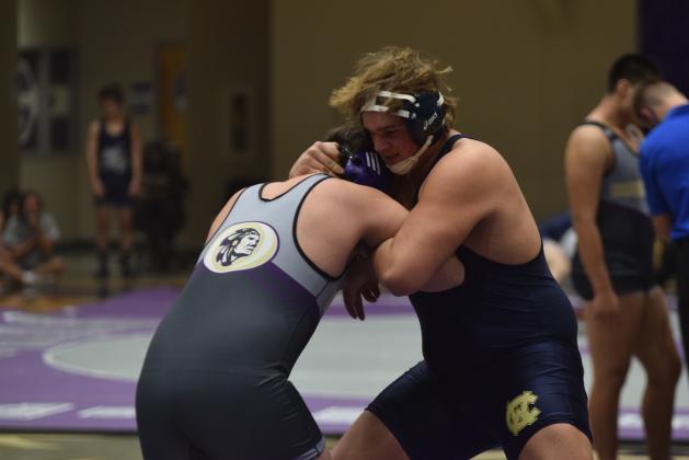 JD Trowell, right, locks up with a Lumpkin County wrestler during the Area Duals last Saturday at Cherokee Bluff. (Photo/Mark Turner)