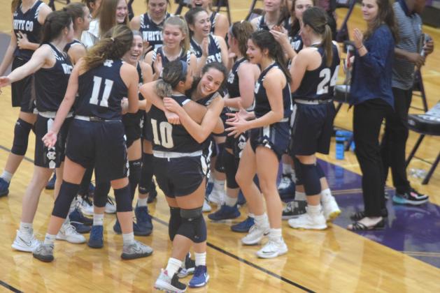 Naomi Roberts, right, shares a hug with Dasha Cannon moments after the win over Lumpkin County. Roberts hit a pair of free throws in the final three seconds of overtime to lift the Lady Warriors to the win. (Photos/Mark Turner)