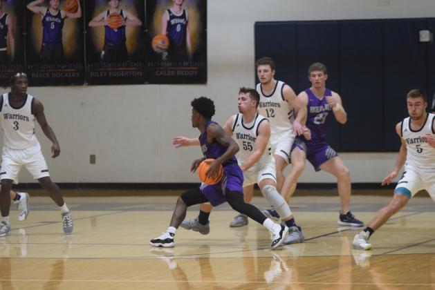 Cooper Turner guards Cherokee Bluff's Shad Dabney during the Warriors' win Tuesday night in Cleveland. (Photo/Mark Turner)