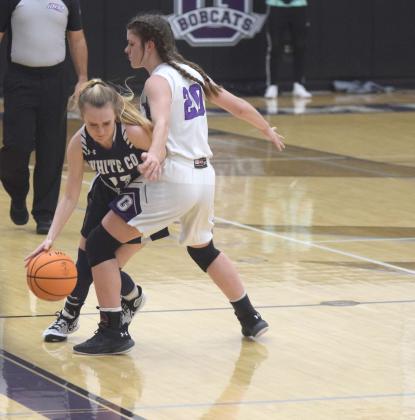 White County's Madison Adams tries to dribble around Gilmer County's Emma Deyton during the region game Tuesday in Ellijay.