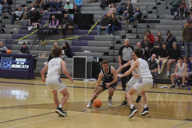 Reece Dockery dribbles past a pair of Gilmer County defenders during the Warriors region win Tuesday night in Ellijay (Photos/Mark Turner)