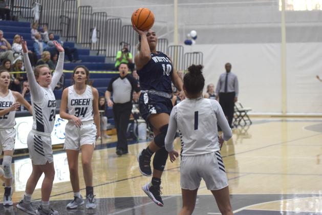 Dasha Cannon scores on a floater in the lane over Coahulla Creek's Ema Turner during the second quarter of the state tournament game Tuesday in Dalton. (Photo/Mark Turner)