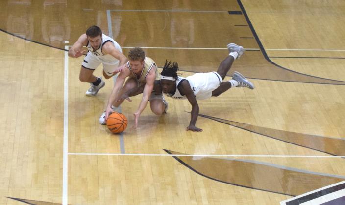 White County's Reece Dockery, left, and Silas Mulligan, and Dawson County's Jadon Gibson dive for a loose ball during the region title game Tuesday in Ellijay. (Photo/Mark Turner)